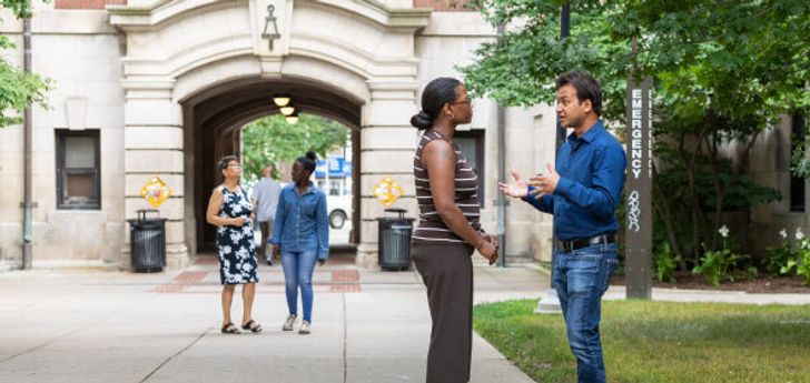 People having conversations on the Diag outside of West Hall