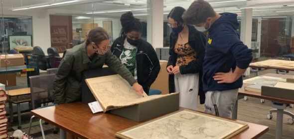 People looking at antique maps