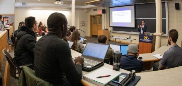 Students in a classroom watching a lecture