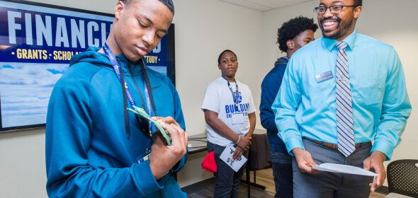 High school students and U-M staff at an urban school recruitment event