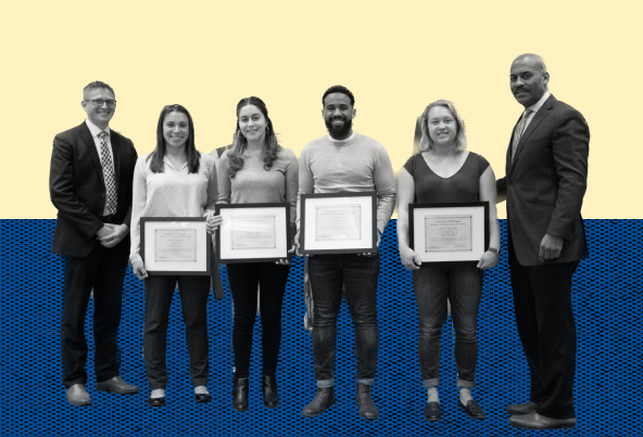 a group of people holding certificates