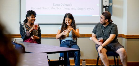 Three people presenting and drinking coffee drinks